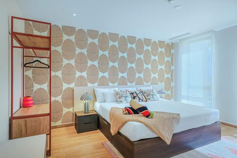 Sink into crisp white linens beneath a striking woven wall feature. Your bedroom blends modern comfort with artisan warmth, ready for restful nights.