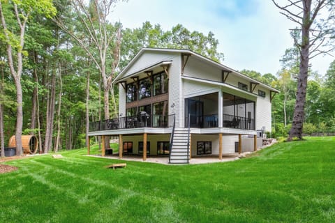 Expansive backyard bordered by peaceful woods, made for time together.