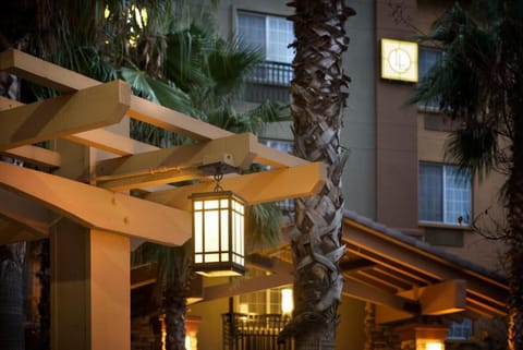 Enjoy evening ambiance with softly lit walkways and palms.