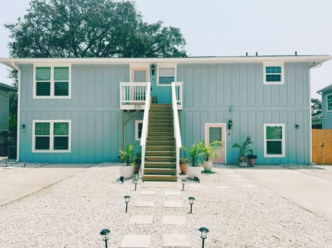 Charming blue duplex with private parking and a bright, welcoming entry