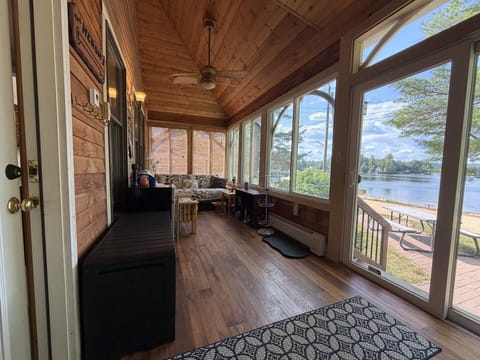 Curl up with your morning coffee in this sunlit screened porch overlooking the lake—the perfect spot to feel the breeze and soak in the peaceful water views.