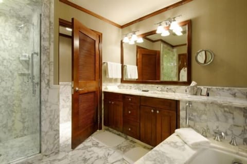 Spa-like marble bathroom with soaking tub and glass walk-in shower