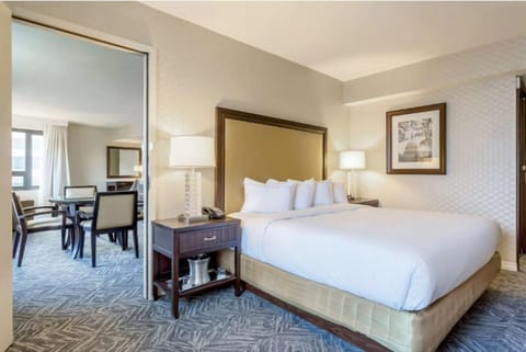 Sink into plush bedding in a bright, spacious suite.