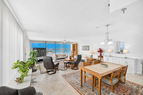 Bright, open living space flooded with natural light and ocean views through floor-to-ceiling windows. Perfect for dining or unwinding in comfort—your coastal retreat awaits.