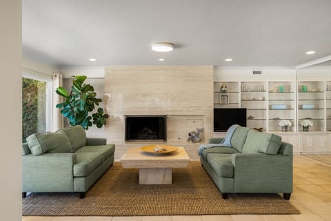 Gather in a bright, welcoming living space featuring comfortable seating, a cozy fireplace, and plenty of room to relax after a day on the water.