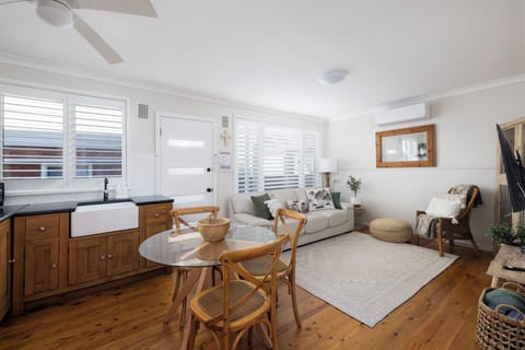 Bright coastal living with cozy lounge, dining nook, and A/C comfort