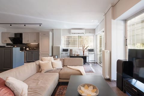 Open-plan living and kitchen, flooded with natural light. The center of Luxe Bliss — where mornings begin and evenings unwind. Booking.com tag: Living room
