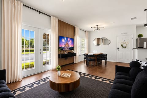 Bright open living space with French doors, dining area, and modern style