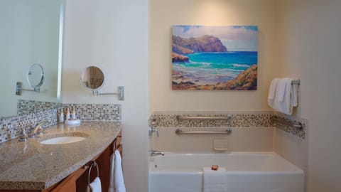 Bright spa-like bathroom with soaking tub and elegant coastal touches