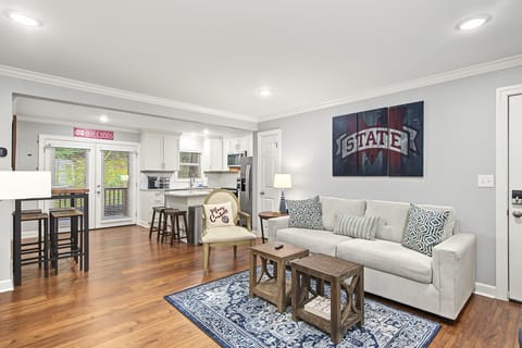 Bright open living space with stylish kitchen and Mississippi State flair