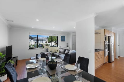 Spacious open-plan layout connecting kitchen, dining, and living