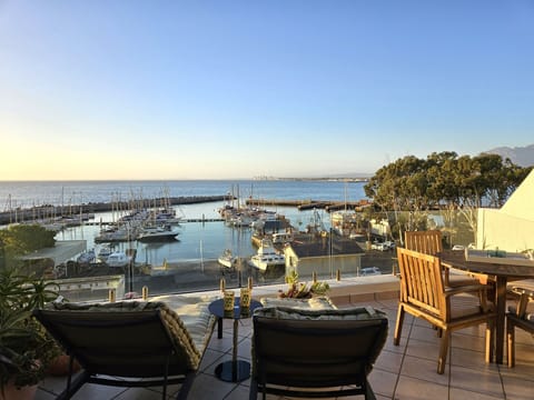 The balcony with a seating area and sun loungers 