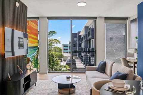 Bright modern lounge with floor-to-ceiling windows and tropical views