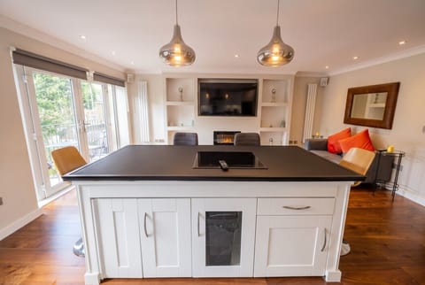 The sleek island kitchen flows into a bright lounge for easy entertaining