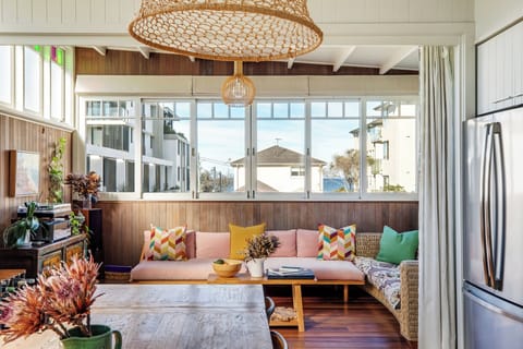Stretch out in the upper-level living area beneath soaring ceilings, where colourful stained-glass windows, ocean glimpses and comfortable seating invite long conversations between beach adventures.