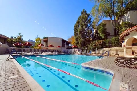 Swim refreshing morning laps in the sunlit outdoor pool.