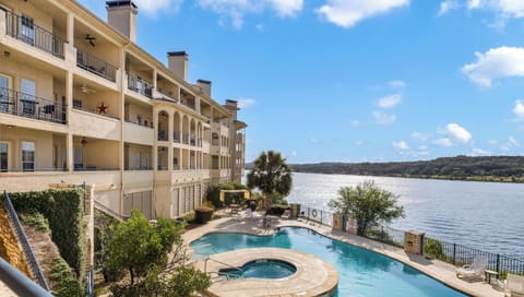 Resort-style waterfront pool and hot tub overlooking Lake Travis at The Island.