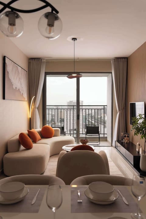 Step into the living room and soak in the stunning river view through floor-to-ceiling glass doors. Whether you're relaxing on the cozy seating or stepping onto the balcony, the serene cityscape creates the perfect backdrop for unforgettable moments