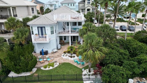 Exterior view of the home with outdoor seating and lush landscaping on multiple levels