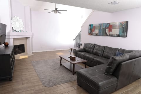 Bright, spacious living room with fireplace and oversized sectional