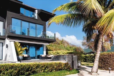 Soak up tropical sunshine beside manicured grounds and glass balconies.