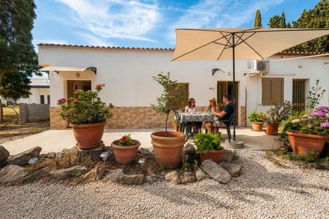 Sunny private courtyard with shaded outdoor dining and Mediterranean charm