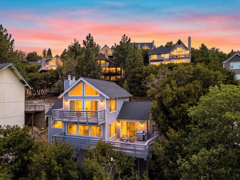 Exterior view of the two-story cabin house at dusk.