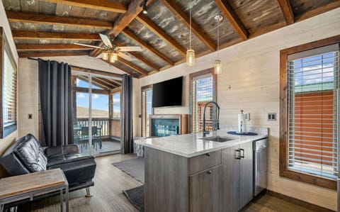 Relax in a warm, rustic living area with a fully equipped kitchen and beautiful outdoor views.