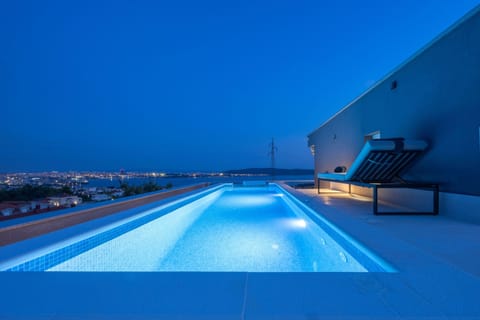 Illuminated Rooftop Pool with Sea View