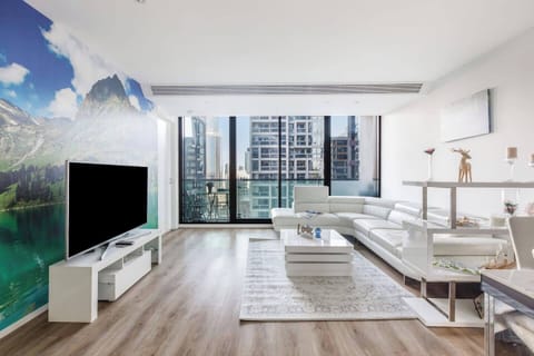 Relax on the leather L-shaped sofa and take in sweeping skyline views through full-height windows, the perfect setting for movie nights or quiet afternoons.