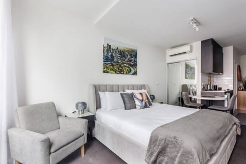 This compact open-plan studio is designed with efficient comfort in mind, seamlessly integrating sleeping, dining, cooking, and workspace zones.