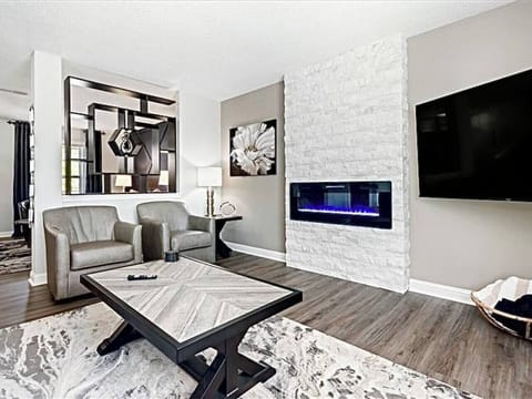 Beautiful family room with custom electric fireplace and big screen tv. 