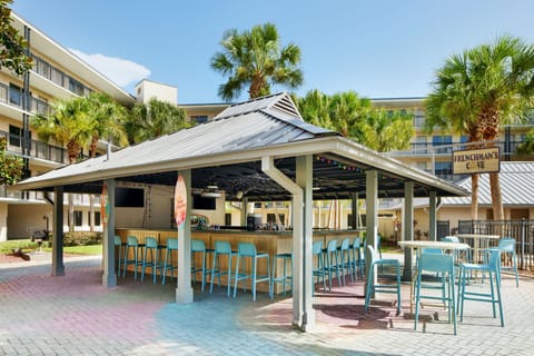 Outdoor bar area with colorful stools.
