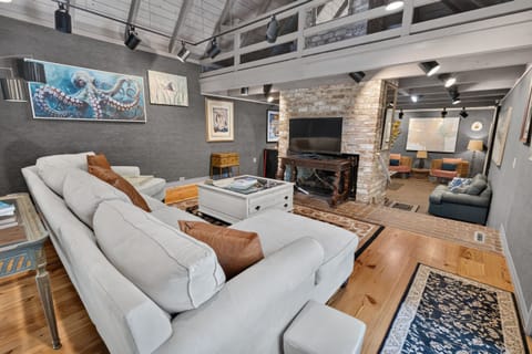 A comfortable living room with plenty of seating, perfect for relaxing after a day at the beach.