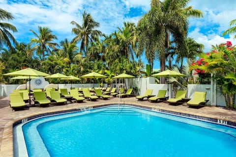 Soak up sunshine poolside with sweeping sea views beyond.