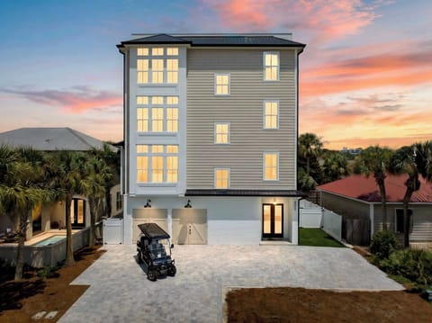 SERENITY SHORES - Brand new 4-story luxury estate that SLEEPS 28! Just steps from PRIVATE beach access, this stunning retreat includes a FREE golf cart. Unwind in the backyard oasis with a heated pool, outdoor kitchen, and lounge seating.