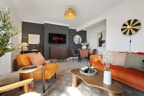 Enjoy a bright and spacious living room with comfortable seating, a Smart TV, complimentary high-speed Wi-Fi, and a dining table. A great place to relax after work or a day of exploring.