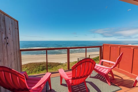 Step out to your private deck and settle into a sunny beach chair overlooking pristine sand and endless ocean views, where gentle waves and seabirds welcome your escape.