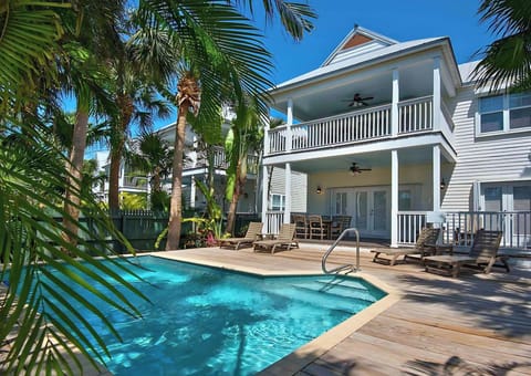 Dive into the sparkling pool and lounge under palms.