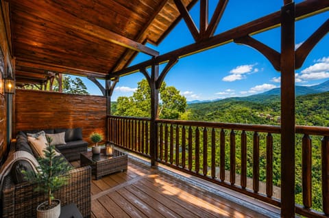 Covered mountain-view deck with cozy seating and sweeping scenic vistas