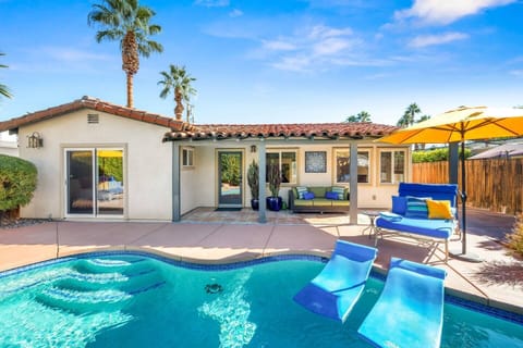 Private pool with rafts, chaise, umbrellas, and covered porch with loveseat
