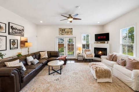 Living Room: Relax in this bright and welcoming living room with comfortable seating, warm décor, and plenty of space to unwind, gather, or enjoy a quiet evening.