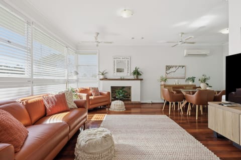 Relax in comfort with natural light streaming through large windows, opening up to a spacious living and dining layout.