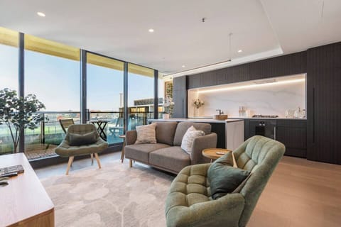 Unwind in a stylish, light-filled living area where modern interiors flow seamlessly onto the main balcony.