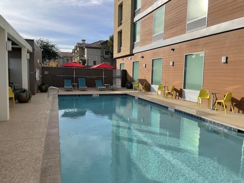 Cool off in the sparkling pool beside relaxed seating.