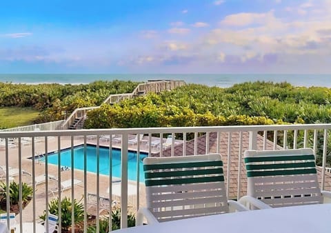 Balcony overlooks the Pelican Building Pool, beach dune, and Atlantic Ocean.