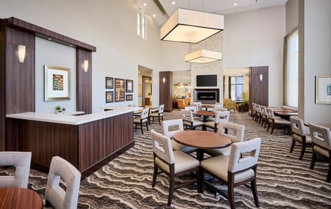 Open common area with lounge furniture and tables.