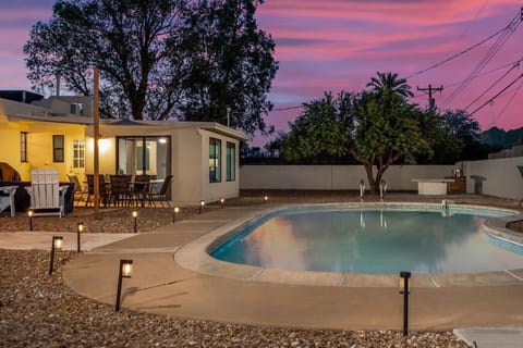 Golden Hour Poolside — Path lights glow as the desert sky turns, framing the unheated pool and the covered patio right off the house