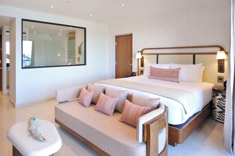 Unwind in a serene king suite with lounge sofa.