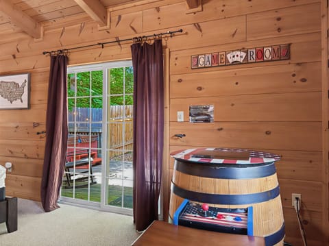 Cozy cabin game room with arcade table and patio access